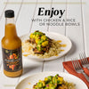 Enjoy the flavorful Full Boar Craft Hot Sauce with chicken and rice or noodle bowls.