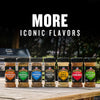 A lineup of McCormick Grill Mates seasonings, including Brown Sugar Bourbon, Montreal Chicken, and the Grill Mates Signature Blend Seasoning, 6.53 Oz Bottle, are displayed on a wooden table outdoors to showcase the brand's iconic flavors.
