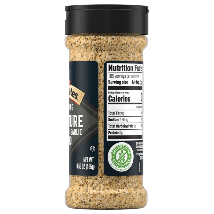 A side view of a clear shaker of Grill Mates Signature Blend Seasoning, 6.53 Oz Bottle, displays the nutrition facts and gluten-free certification on the label.