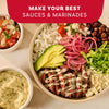 A delicious steak burrito bowl is shown with a creamy sauce made from Mccormick Chimichurri Flavored Seasoning, 2.47 Oz, alongside bowls of pico de gallo and extra sauce.