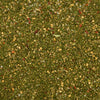 A close-up, top-down view reveals the vibrant texture of Mccormick Chimichurri Flavored Seasoning, 2.47 Oz, showing a mix of green herbs, red pepper flakes, and other spices.