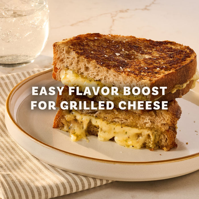 A perfectly toasted grilled cheese sandwich, cut in half and stacked, demonstrates an easy flavor boost using Mccormick Caramelized Onion Seasoning, 4.66 Oz.