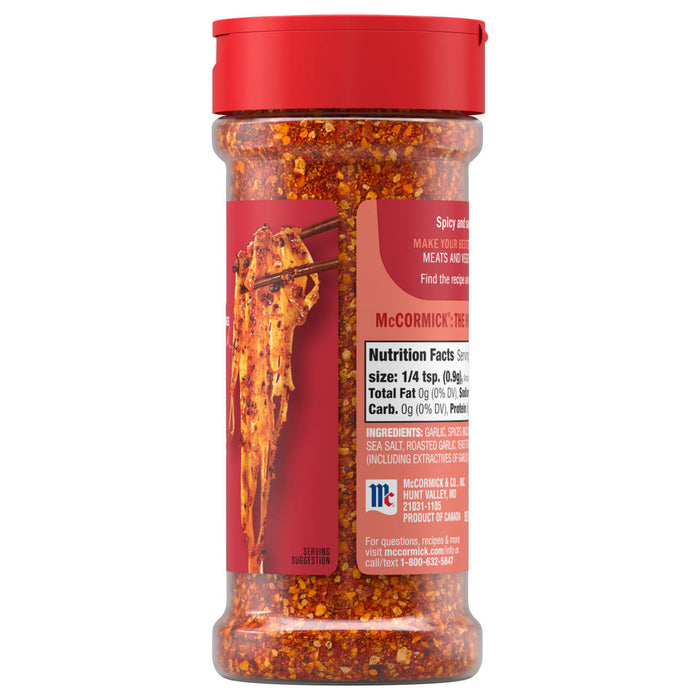 A clear bottle of Mccormick, 5.22 Oz spice blend shows the red and orange flakes inside, with a label featuring a serving suggestion of seasoned noodles.