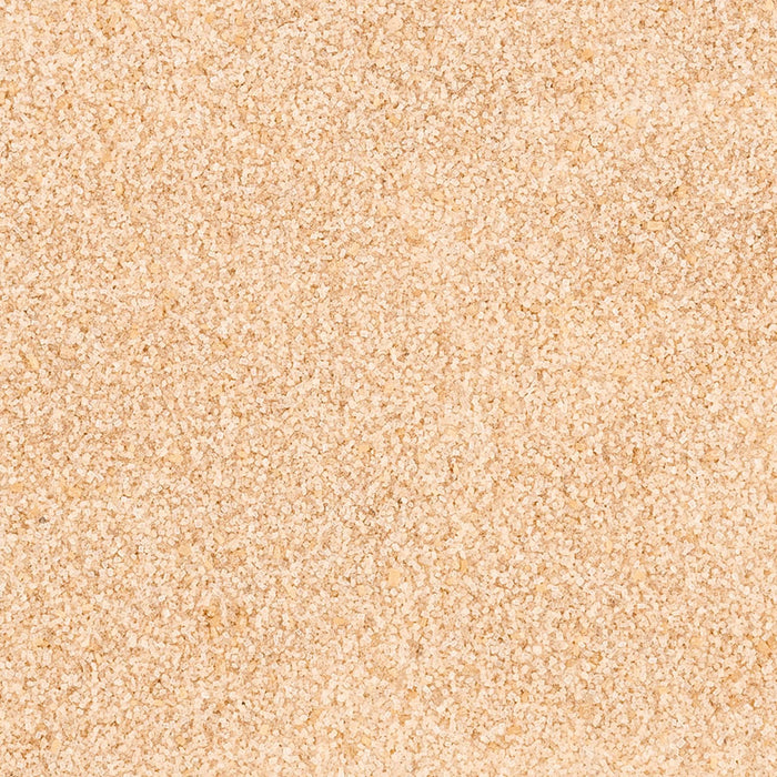 The granular, light brown texture of Mccormick Cinnamon Roll Finishing Sugar, 3.81 Oz, is shown in a close-up shot.