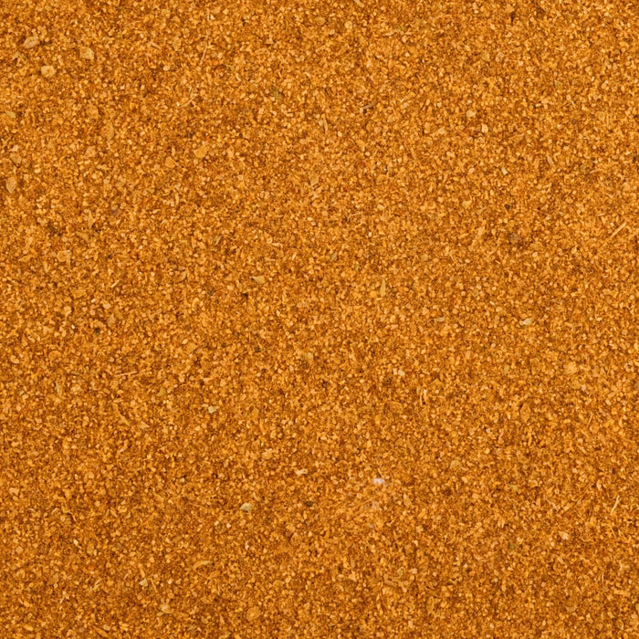 A close-up, top-down view shows the granular, orange-brown texture of Mccormick Peruvian Style Seasoning, 5.48 Oz.