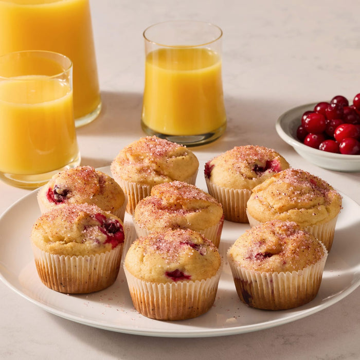 A plate of muffins topped with cranberry finishing sugar.