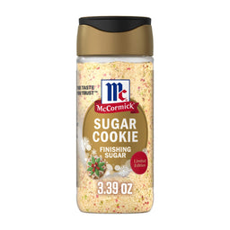 A clear plastic bottle of Mccormick Sugar Cookie Finishing Sugar, 3.39 Oz features a festive label with snowflakes and a decorated cookie illustration.