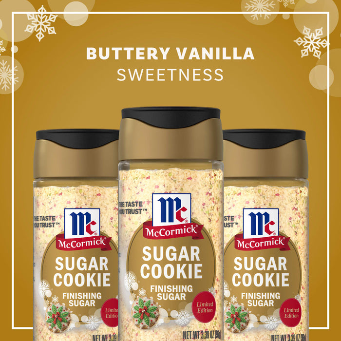 Three bottles of Mccormick Sugar Cookie Finishing Sugar, 3.39 Oz are displayed against a festive gold background with snowflakes to highlight the buttery vanilla sweetness of the limited edition holiday blend.
