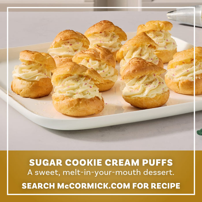 A platter of sugar cookie cream puffs is beautifully decorated with a dusting of Mccormick Sugar Cookie Finishing Sugar 3.39 Oz for a sweet and melt-in-your-mouth dessert experience.