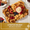 A festive holiday brunch board features waffles, pancakes, and French toast sticks all dusted with Mccormick Sugar Cookie Finishing Sugar, 3.39 Oz and served with fresh berries and whipped cream.