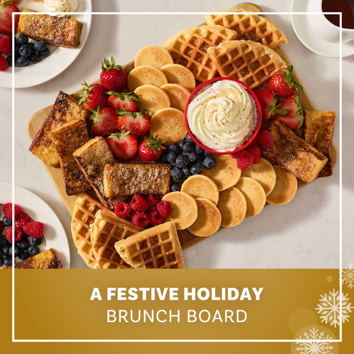 A festive holiday brunch board features waffles, pancakes, and French toast sticks all dusted with Mccormick Sugar Cookie Finishing Sugar, 3.39 Oz and served with fresh berries and whipped cream.