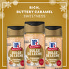 Three bottles of Mccormick Dulce De Leche Finishing Sugar, 3.43 Oz are displayed against a festive gold background with snowflakes to highlight its rich and buttery caramel sweetness.
