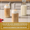 Two glasses of Dulce De Lece Shaken Espresso are topped with a creamy foam and a sprinkle of Mccormick Dulce De Leche Finishing Sugar 3.43 Oz next to a bottle of milk.