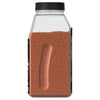 A bottle of chili powder with a grip on the side.