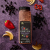 A jar of McCormick Flavor of the Year 2026 Sweet &amp; Smoky Naturally Flavored Black Currant Seasoning is displayed with black currants, red peppers, and toasted onions.