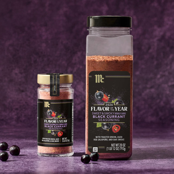 Two containers of McCormick Flavor of the Year 2026 Sweet &amp; Smoky Naturally Flavored Black Currant Seasoning are displayed against a purple background.