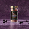 A jar of McCormick 2026 Flavor of the Year Sweet &amp; Smoky Naturally Flavored Black Currant Seasoning is surrounded by black currants.