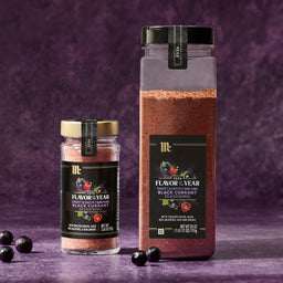 Two containers of McCormick Flavor of the Year 2026 Sweet &amp; Smoky Naturally Flavored Black Currant Seasoning are displayed against a purple background.
