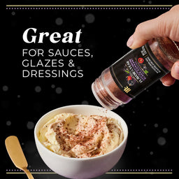 A hand sprinkles McCormick Flavor of the Year 2026 Sweet &amp; Smoky Black Currant Seasoning onto a bowl of cream.