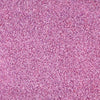 A close-up shows a dense layer of pink-colored sugar crystals, creating a textured and sparkling surface.