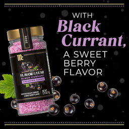 A jar of McCormick Flavor of the Year Black Currant Finishing Sugar is displayed with fresh black currants.