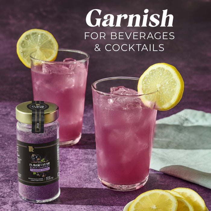 A jar of McCormick Flavor of the Year 2026 Black Currant Finishing Sugar is displayed with two cocktails garnished with lemon slices.
