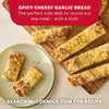 Slices of spicy cheesy garlic bread, seasoned with Mccormick Spicy Sicilian Style Seasoning, 1.62 Oz, are arranged on a wooden board and a plate to showcase a recipe from McCormick.
