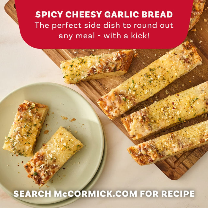Slices of spicy cheesy garlic bread, seasoned with Mccormick Spicy Sicilian Style Seasoning, 1.62 Oz, are arranged on a wooden board and a plate to showcase a recipe from McCormick.