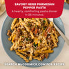 A close-up of a blue plate filled with Savory Herb Parmesan Pepper Pasta, a delicious meal idea made with Mccormick Savory Herb Parmesan Seasoning, 2.5 Oz.