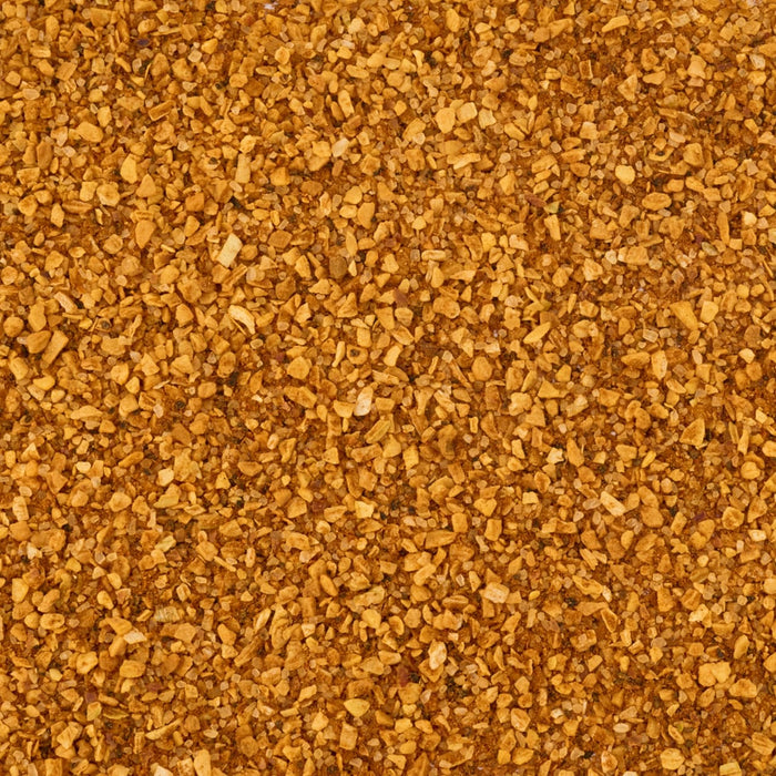 A close-up, top-down view reveals the coarse, golden-brown texture of Mccormick Smoked Paprika And Garlic Seasoning, 3.12 Oz.