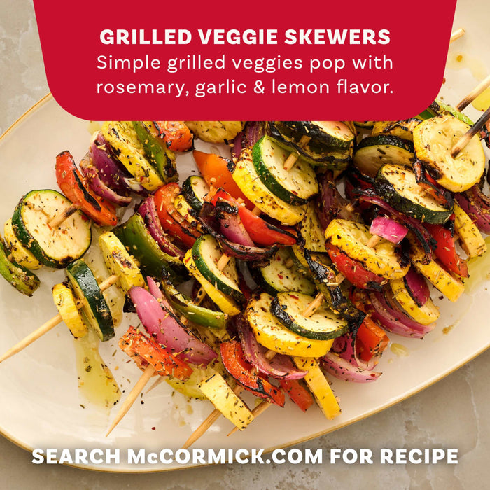 Grilled veggie skewers with zucchini, squash, and peppers are shown on a white plate, seasoned with Mccormick Rosemary Lemon Seasoning, 2.75 Oz to create a simple dish with rosemary, garlic, and lemon flavor.