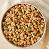 A fresh bean salad with chickpeas and diced vegetables is presented in a bowl, showcasing a recipe made with Mccormick Rosemary Lemon Seasoning, 2.75 Oz.