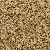 An overhead, close-up view displays the texture and ingredients of Mccormick Sesame Ginger Seasoning, 2.5 Oz, including black and white sesame seeds, and dried garlic.