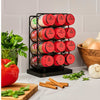 The image features a Mccormick Spice Rack Red Cap Black Metal 12 Ct, holding jars of garlic salt, cumin, paprika, smoked paprika, thyme, oregano, onion, cinnamon, crushed pepper, chili, and basil, displayed on a kitchen counter with fresh produce.