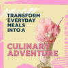 A graphic advertisement for a product like Mccormick, 10.49 Oz, features an elaborate pink milkshake topped with cotton candy next to the text, Transform everyday meals into a culinary adventure.