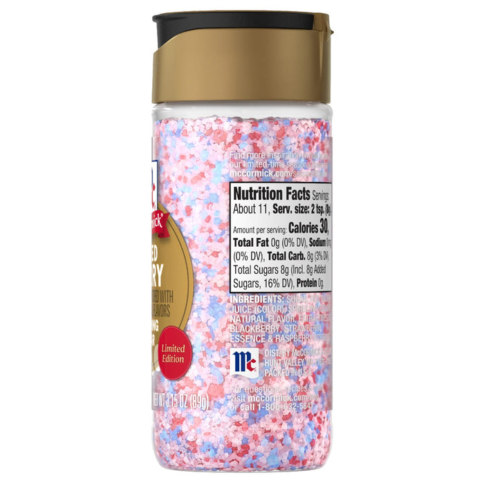 The back of a bottle of Mc Mixed Berry Fin Sgr 72/6/3.15 Oz, showing the nutrition facts and ingredients list against a background of the red, white, and blue sugar crystals inside.