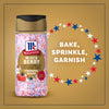 A bottle of the Mc Mixed Berry Fin Sgr 72/6/3.15 Oz is shown against a gold background with red, white, and blue stars and the words Bake, Sprinkle, Garnish, highlighting its use for festive desserts.