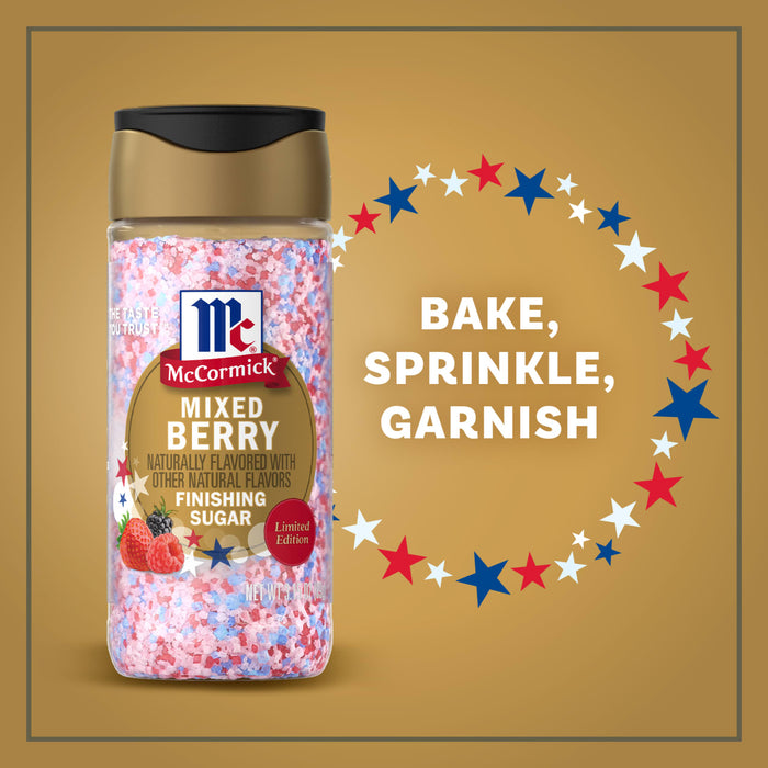 A bottle of the Mc Mixed Berry Fin Sgr 72/6/3.15 Oz is shown against a gold background with red, white, and blue stars and the words Bake, Sprinkle, Garnish, highlighting its use for festive desserts.