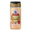 A clear shaker bottle of Mccormick Apple Pie Finishing Sugar, 3.06 Oz, is shown against a white background, featuring a label with a picture of an apple pie slice.