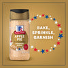 A bottle of Mccormick Apple Pie Finishing Sugar, 3.06 Oz is shown against a golden background with red, white, and blue stars and the words Bake, Sprinkle, Garnish.