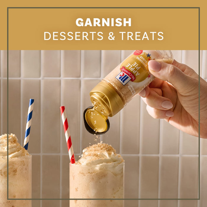 A hand sprinkles Mccormick Apple Pie Finishing Sugar, 3.06 Oz over a milkshake topped with whipped cream to demonstrate how to garnish desserts and treats.