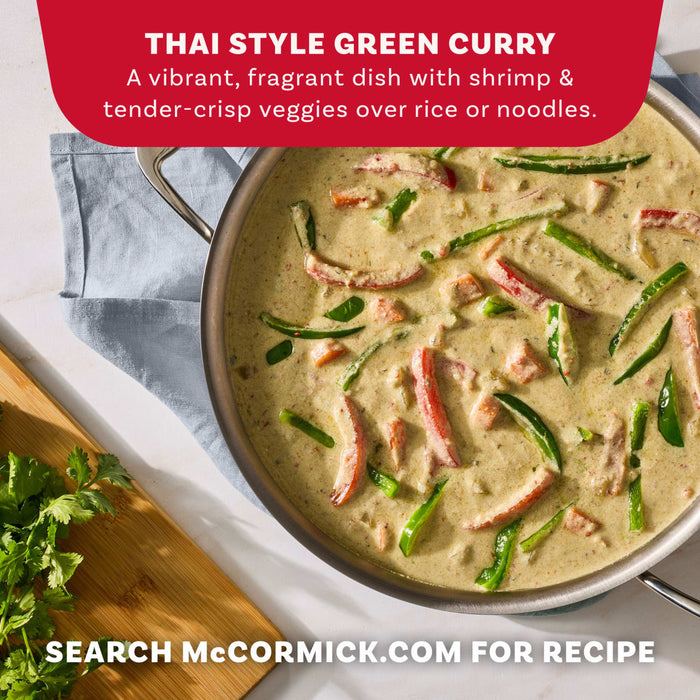 A large stainless steel pan filled with a vibrant Thai Style Green Curry featuring shrimp and tender-crisp vegetables prepared with Mc Thai Gn Curry Mix.