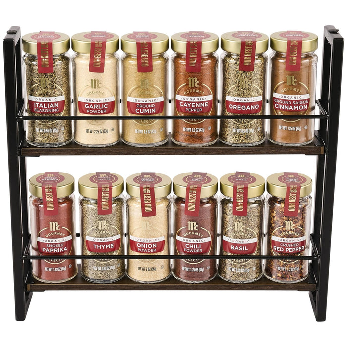 A two-tier black metal spice rack holds twelve glass jars of McCormick, 15.24 Oz organic gourmet spices including Italian seasoning, garlic powder, and crushed red pepper.