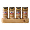 The Mccormick Finishing Sugar Caddy 4Ct is displayed against a white background, holding four jars of finishing sugar in Cinnamon Roll, Vanilla Cake, Chocolate Hazelnut, and Salted Caramel flavors.