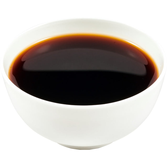 ['A white bowl filled with dark liquid.']