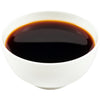 A white bowl filled with dark liquid.