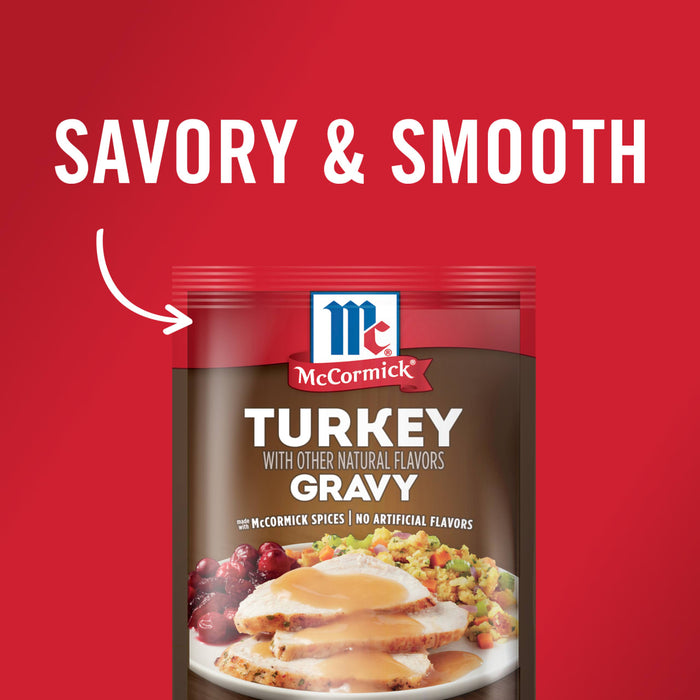 ['A package of McCormick Turkey Gravy with a picture of sliced turkey with gravy, cranberry sauce, and stuffing on a white plate.']
