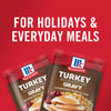 ['Two McCormick Turkey Gravy packets with a picture of a turkey dinner on the front.']