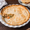 ['A close up of a chicken pot pie with a flaky crust and a creamy filling.']