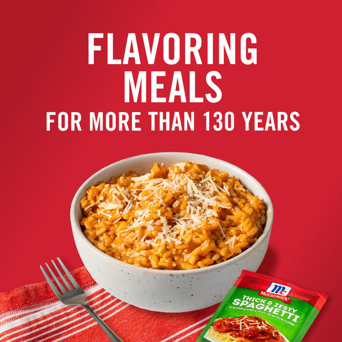 ['A bowl of cheesy tomato risotto with a McCormick Thick &amp; Zesty Spaghetti seasoning packet.']